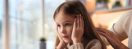 Enfant anxieuse réconfortée par la main rassurante d'un adulte — SANUSq Health